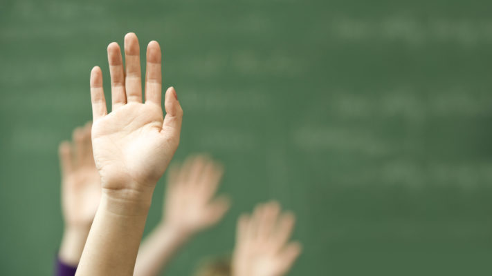 Hands raised in classroom